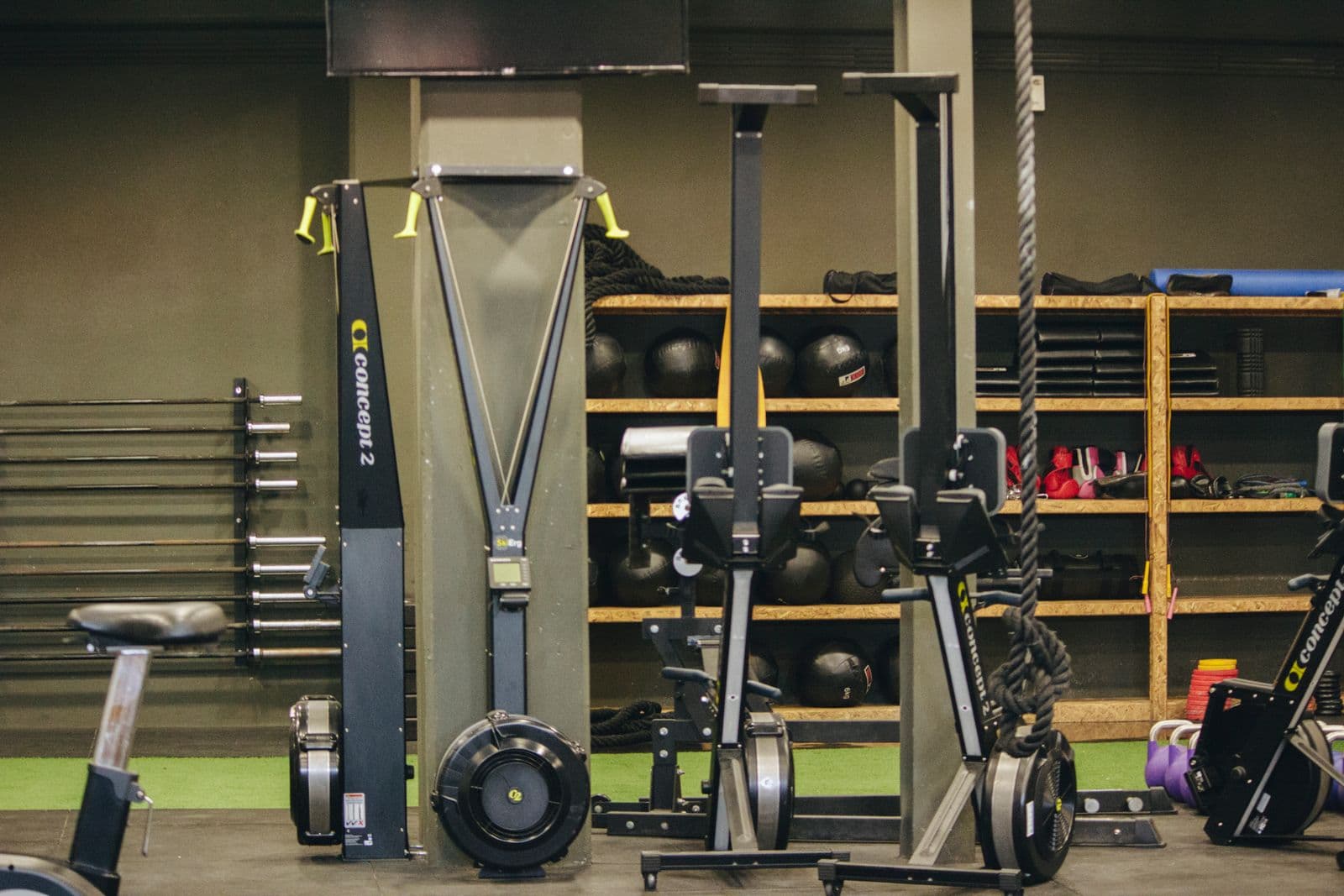 Studio with rowing machines, medicine balls and a climbing rope