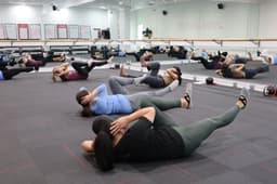 Diverse group of participants exercising side by side during an indoor fitness class