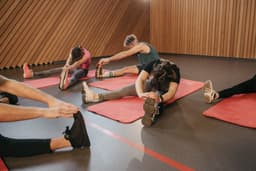 Energetic group workout session with participants training together on mats