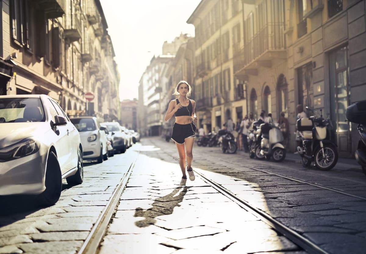 Member running outdoors at golden hour after a transformation