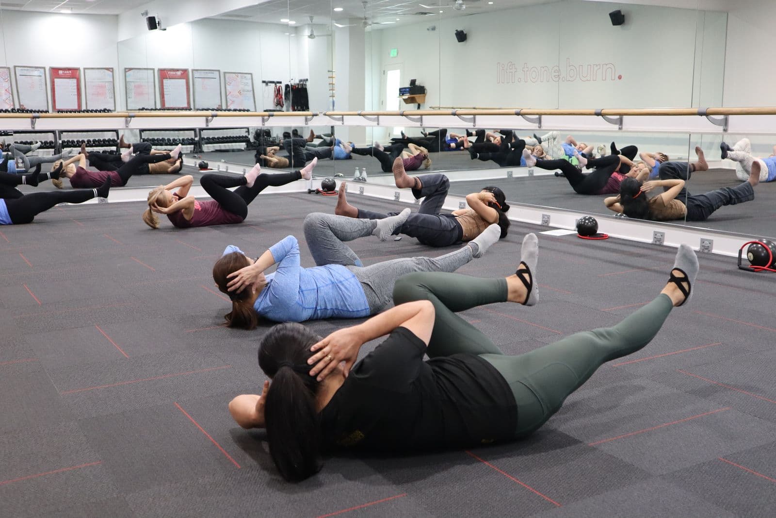 Diverse group conditioning class training side by side
