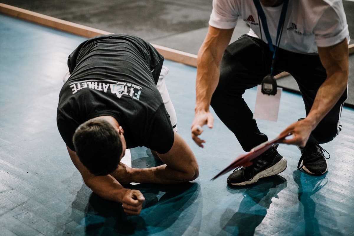 Fitness coach guiding a client through an exercise